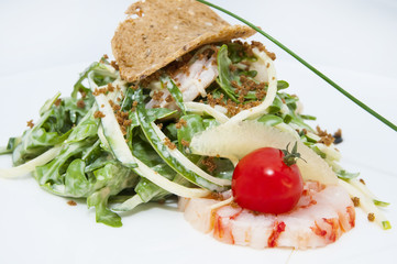 salad greens and shrimp meat on a white background