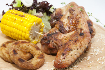 chicken wings are grilled on a wooden platter