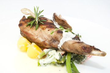 roasted rabbit meat and potatoes with vegetables