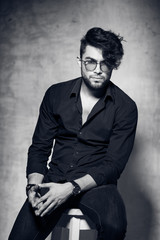 Fototapeta premium sexy fashion man model dressed casual wearing glasses posing