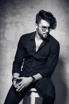 sexy fashion man model dressed casual wearing glasses posing