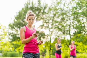 blond woman listening to music during sport