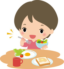 朝食のサラダを食べる女性