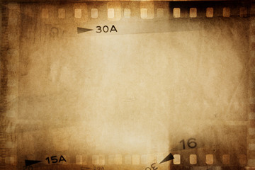 Brown film strips negatives frames movie background. Copy space