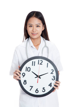 Young Asian female doctor hold a clock