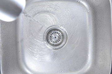 Water Flowing Down In The Hole In A Kitchen Sink 