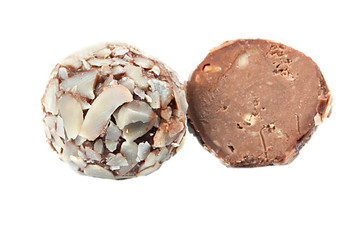 Bonbon of tasty milk chocolate with nut crumbs