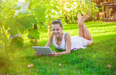 girl with notebook on green grass