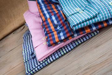 Men's shirts on wooden table