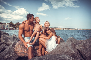 family on the stone coast near the sea