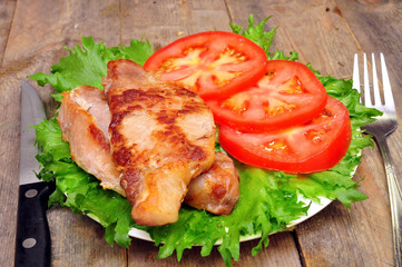 meat chops with tomatoes in a bowl