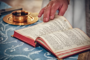 Naklejka premium church utensil and bible on an alta