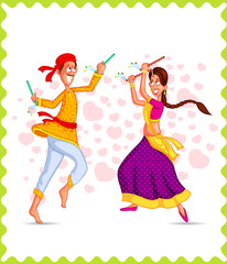 Fototapeta na wymiar Couple performing Dandiya