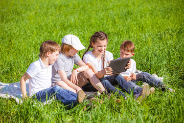Fototapeta premium Five friends sitting on grass