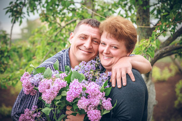 Happy old couple with flower outdoor
