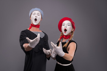 Portrait of funny mime couple with white faces and emotions isol