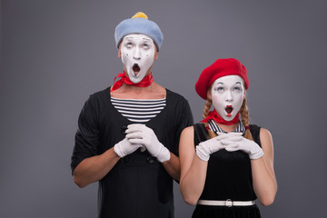 Portrait of funny mime couple with white faces and emotions isol