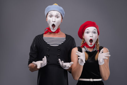 Portrait of funny mime couple with white faces and emotions isol