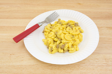 Mac and cheese meal on paper plate with fork