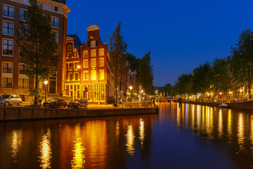 Fototapeta na wymiar Night city view of Amsterdam canal and bridge