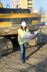 Young female architect at the construction site of the construct