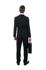 Rear View Of Businessman Carrying Briefcase