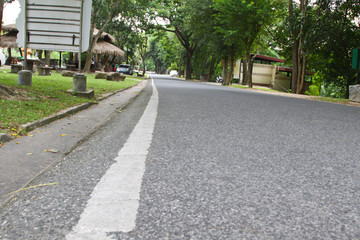 Fototapeta na wymiar Asphalt road texture with left white stripe