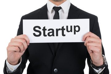 Businessman Holding Startup Sign