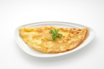 Omelet with celery leaves on white plate