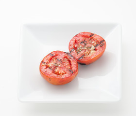 Fried tomatoes on white plate