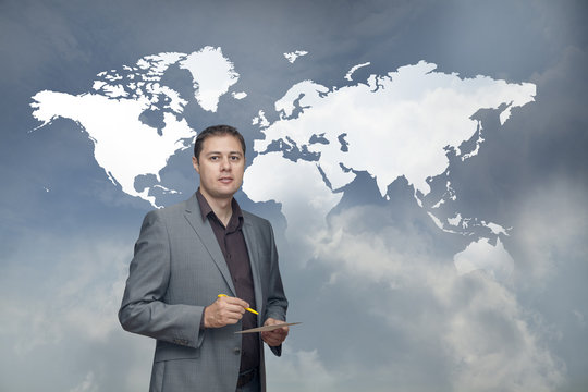 Business man solving problems with world map behind
