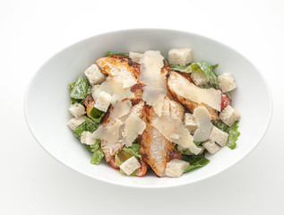 Caesar salad with cheese on white plate