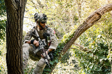 Soldier in uniform of the U.S. Army on the trees