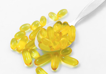 Fish Oil Pills on Spoon Isolated