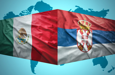 Fototapeta premium Waving Serbian and Mexican flags