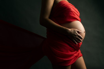 expectant mother holding her belly
