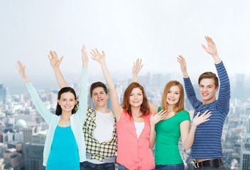 group of smiling students waving hands