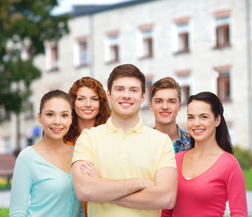 group of smiling teenagers over campus background