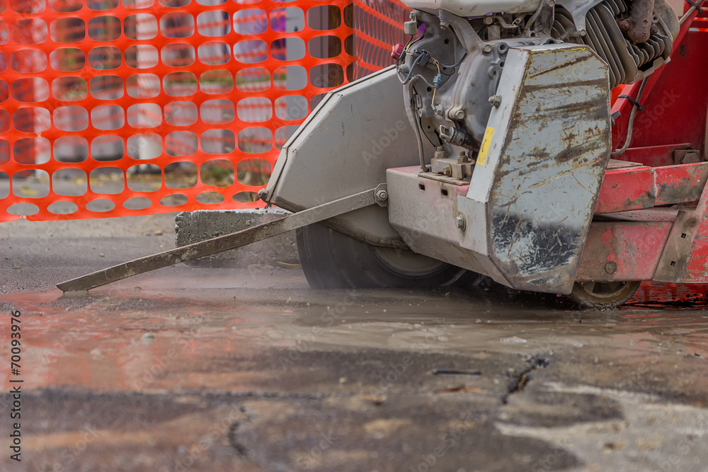 Wall mural close up of cutting asphalt road with diamond saw blade