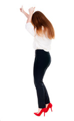 back view of standing young redhead business woman showing thumb