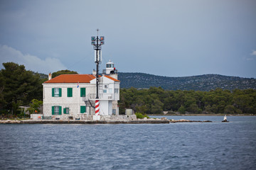 Fototapeta na wymiar Small lighthouse in a Sibenik bay entrance, Croatia