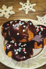 profiteroles with chocolate icing and colored powder