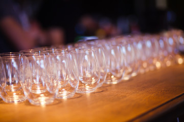 Beautiful line of different coloured cocktails on a open air par
