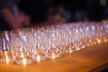 Beautiful line of different coloured cocktails on a open air par