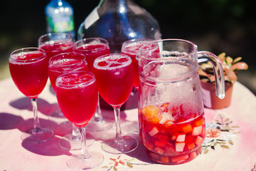 Beautiful line of different coloured cocktails on a open air par