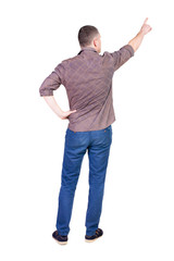 Fototapeta premium Back view of pointing young men in shirt and jeans.