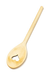 Wooden spoon with the heart shape hole on the white background
