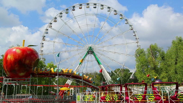Ferris wheel and rides in the amusement park 