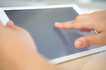 Woman hand hold  white tablet with blank empty screen