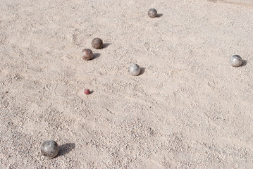 Metallic petanque balls and a small red jack